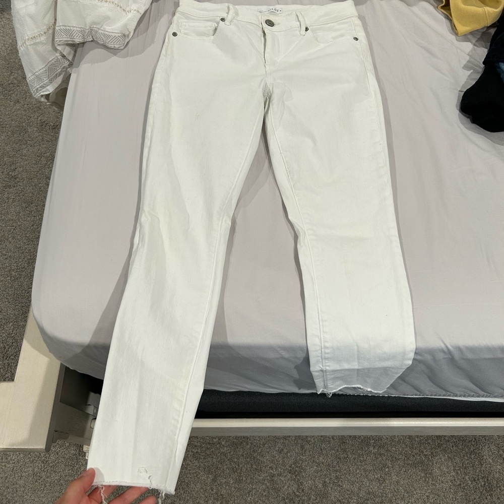 White skinny jeans from Loft. Raw hem. Size 27